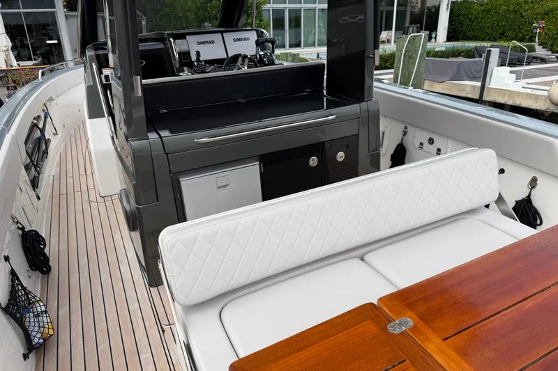  Yacht Photos Pics 2023 Schaefer V33 yacht interior with white seating and wooden table.