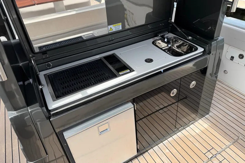  Yacht Photos Pics Outdoor kitchen on 2023 Schaefer V33 yacht with grill, sink, and storage.