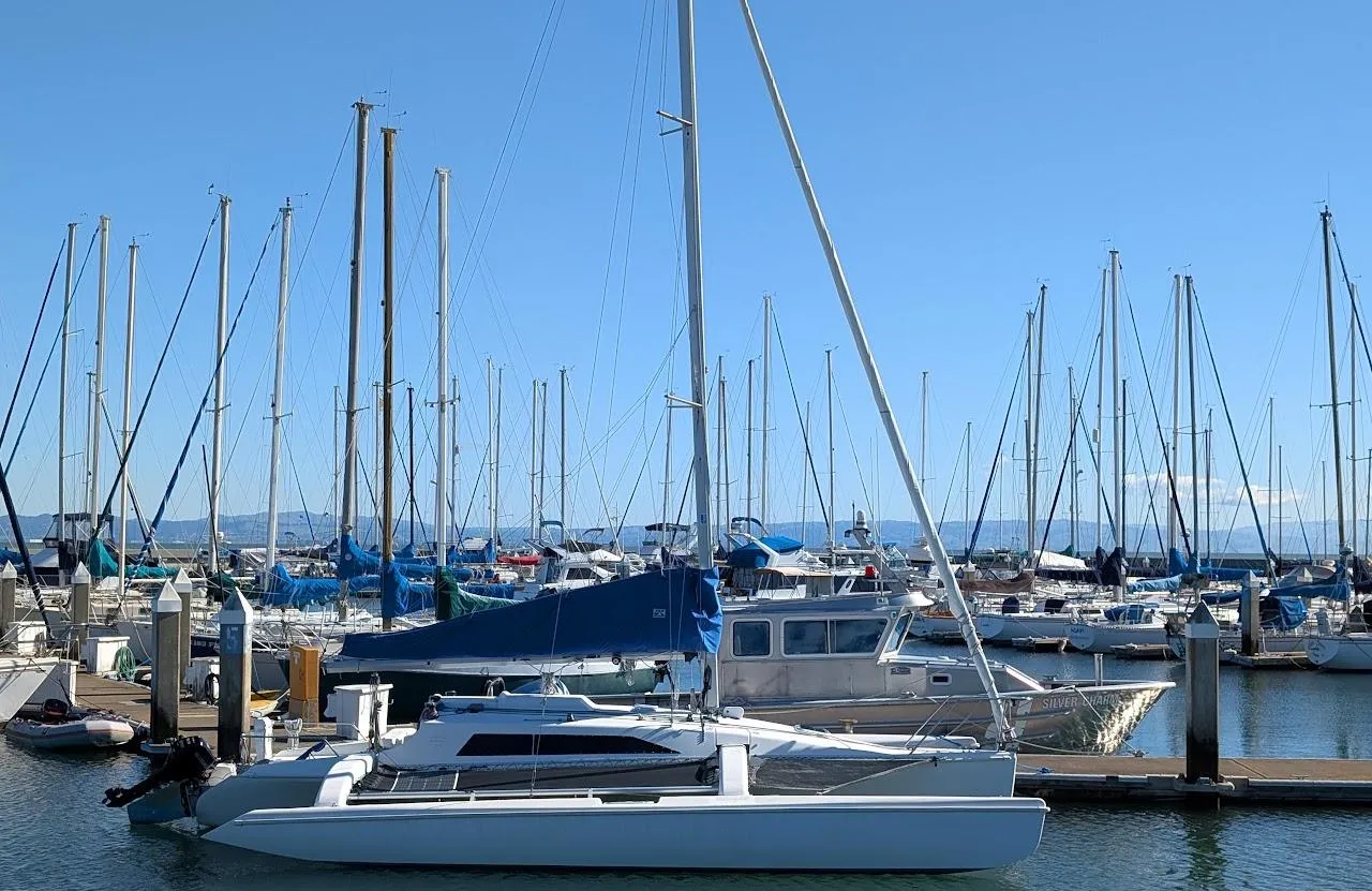 Sailboats docked at marina, featuring a 1996 Corsair F-31 trimaran in the foreground.