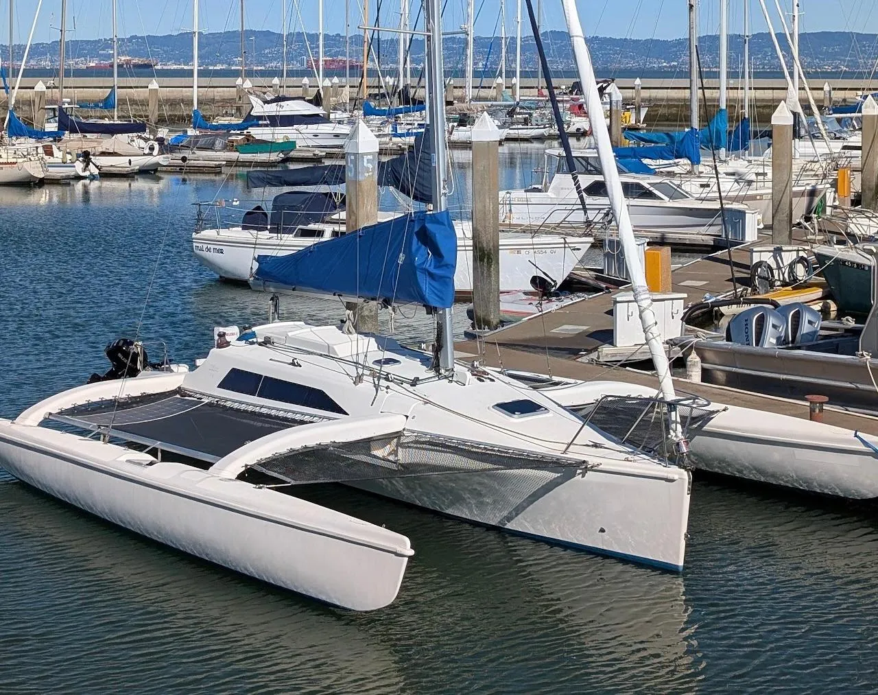 Corsair F-31 trimaran sailboat docked in a marina, 1996 model.