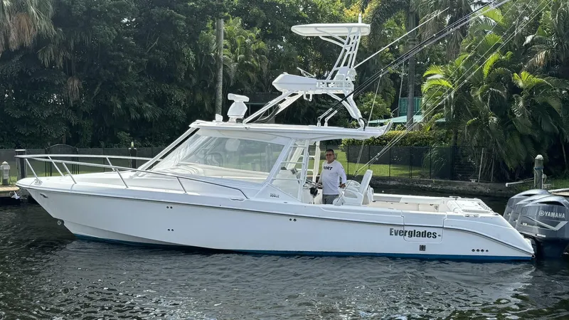 T-party Yacht Photos Pics 2012 Everglades LX 350 boat on water, surrounded by lush greenery.