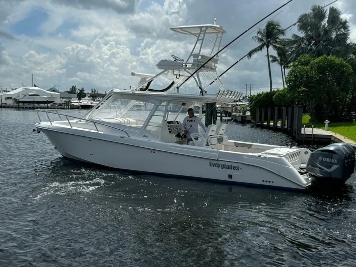 T-party Yacht Photos Pics 2012 Everglades LX 350 boat on water, with palm trees and marina in background.