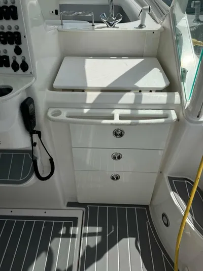 T-party Yacht Photos Pics 2012 Everglades LX 350 boat interior with storage drawers and control panel.