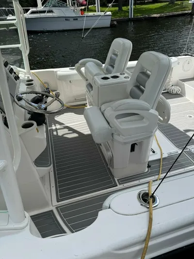 T-party Yacht Photos Pics 2012 Everglades LX 350 boat interior with dual captain chairs and steering wheel.