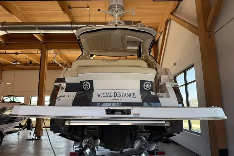 Social Distance Yacht Photos Pics 2019 Regal 35 Sport Coupe boat named "Social Distance" in a wooden interior setting.