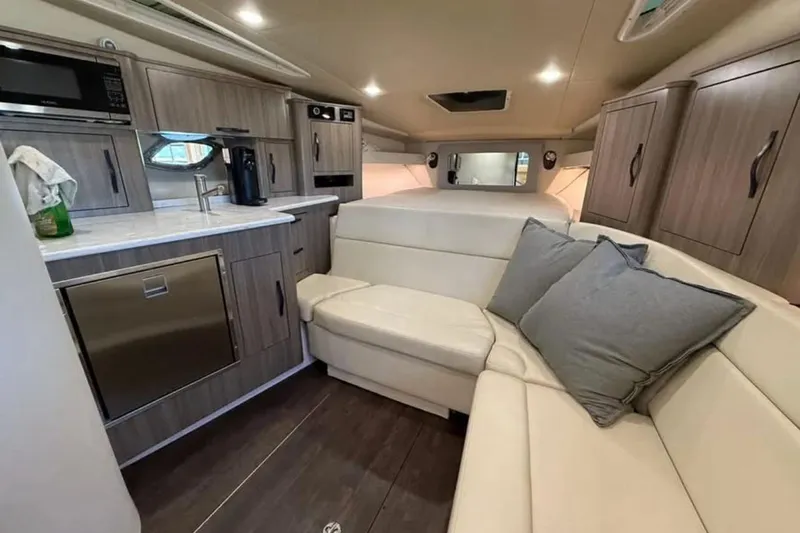Social Distance Yacht Photos Pics 2019 Regal 35 Sport Coupe interior with modern kitchen and cozy seating area.