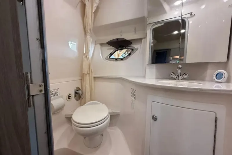 Social Distance Yacht Photos Pics Bathroom interior of 2019 Regal 35 Sport Coupe with modern fixtures and mirror.