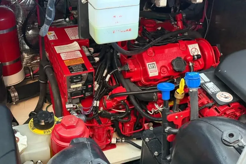 Social Distance Yacht Photos Pics Engine compartment of a 2019 Regal 35 Sport Coupe with red components and wiring.