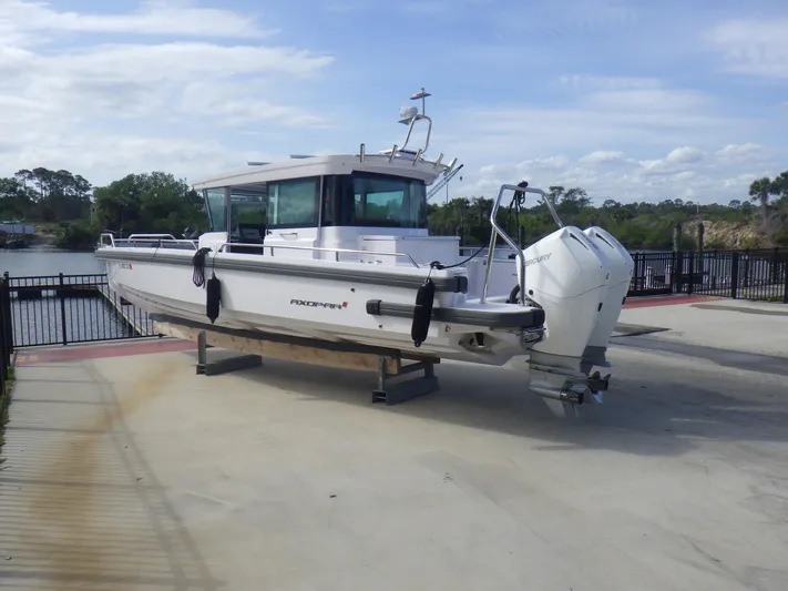  Yacht Photos Pics 2021 Axopar 28 CABIN boat on a dock, featuring twin outboard engines.