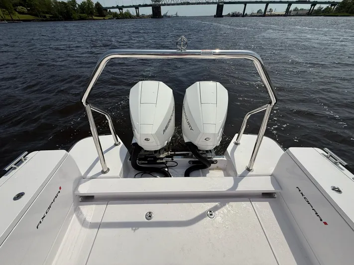  Yacht Photos Pics 2021 Axopar 28 CABIN boat with dual outboard engines on a river.