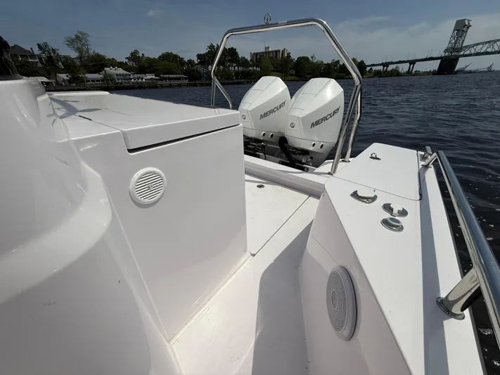  Yacht Photos Pics 2021 Axopar 28 CABIN boat with dual Mercury engines on a calm river.