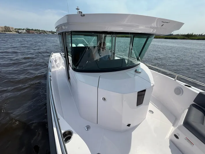  Yacht Photos Pics 2021 Axopar 28 CABIN boat on water, showcasing sleek design and modern features.