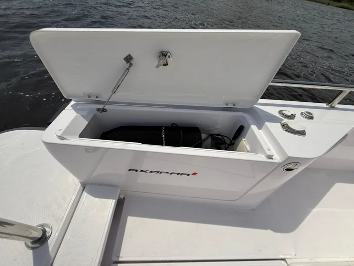  Yacht Photos Pics Open storage compartment on 2021 Axopar 28 CABIN boat, showing interior space.