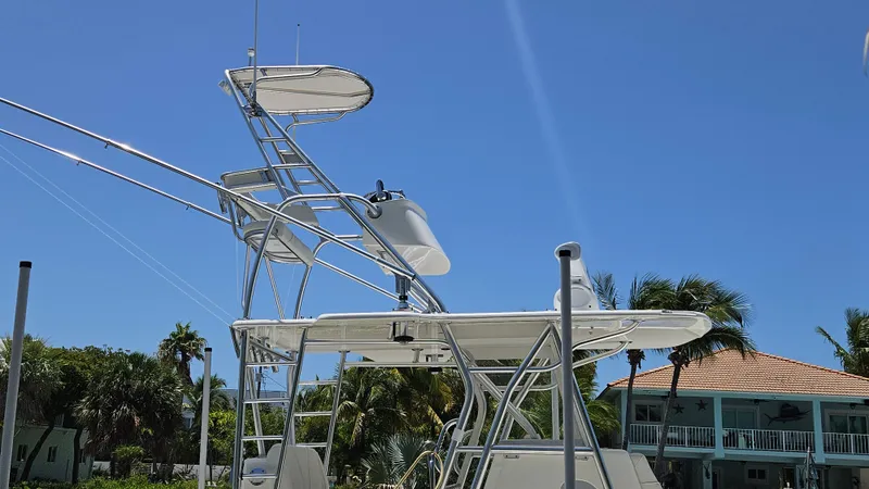  Yacht Photos Pics 2023 SeaVee 370z boat tower against clear blue sky and palm trees.