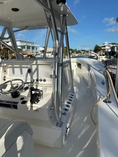  Yacht Photos Pics 2023 SeaVee 370z boat with sleek console and modern design, docked under clear blue skies.