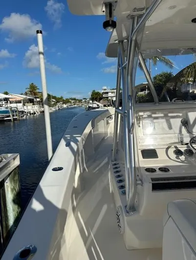  Yacht Photos Pics 2023 SeaVee 370z boat docked in a sunny marina with clear blue skies.