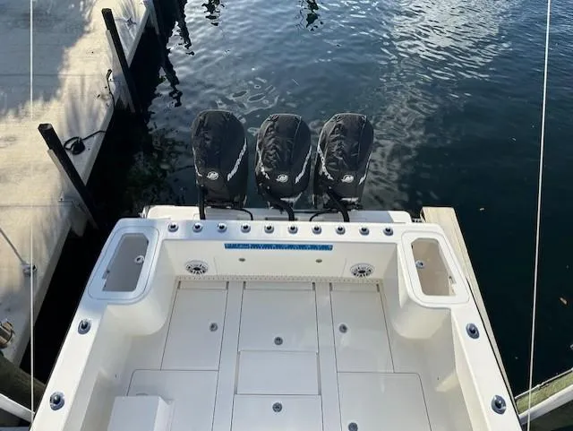  Yacht Photos Pics 2023 SeaVee 370z boat with triple outboard engines docked at marina.