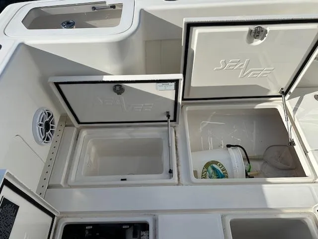  Yacht Photos Pics 2023 SeaVee 370z boat storage compartments with open hatches and visible equipment.