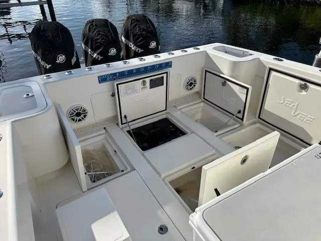  Yacht Photos Pics 2023 SeaVee 370z boat deck with storage compartments and Mercury outboard engines.