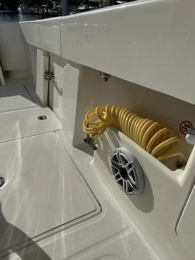  Yacht Photos Pics 2023 SeaVee 370z boat deck with coiled hose and speaker.