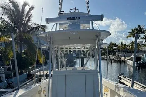  Yacht Photos Pics 2023 SeaVee 370z boat docked by palm trees and waterfront homes.