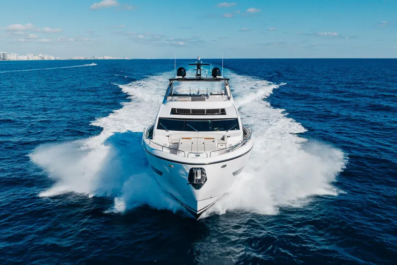 White Star Yacht Photos Pics 2023 Sunseeker 90 Ocean yacht cruising on open sea under clear blue sky.