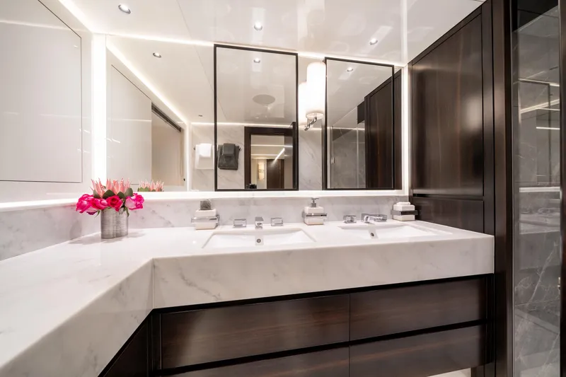 White Star Yacht Photos Pics Luxurious bathroom in 2023 Sunseeker 90 Ocean yacht with marble countertops and elegant lighting.