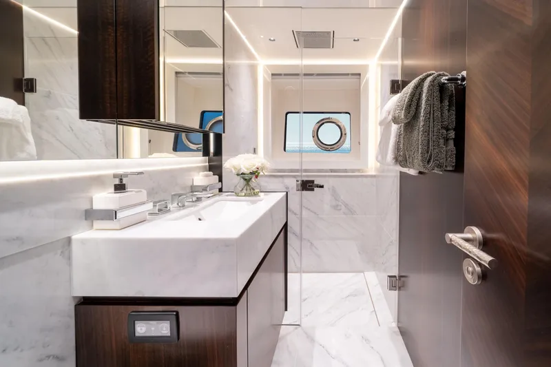White Star Yacht Photos Pics Luxurious bathroom in 2023 Sunseeker 90 Ocean yacht with marble finishes and modern fixtures.