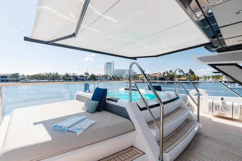 White Star Yacht Photos Pics Luxurious Sunseeker 90 Ocean yacht deck with pool, 2023 model, overlooking serene waterfront.
