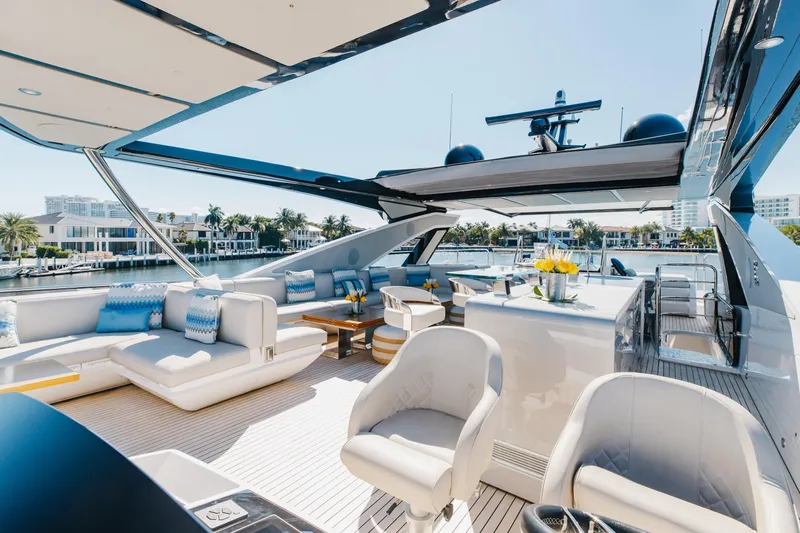 White Star Yacht Photos Pics Luxurious 2023 Sunseeker 90 Ocean yacht deck with elegant seating and waterfront view.