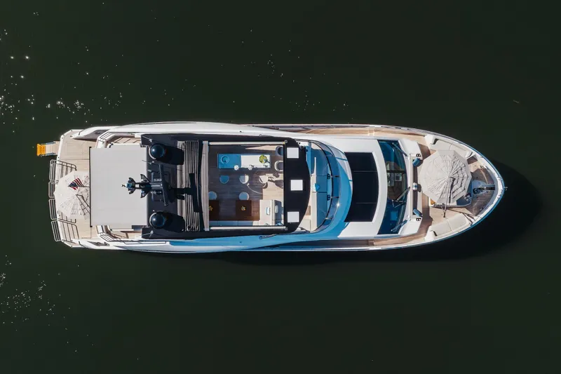 White Star Yacht Photos Pics Aerial view of 2023 Sunseeker 90 Ocean luxury yacht on calm water.