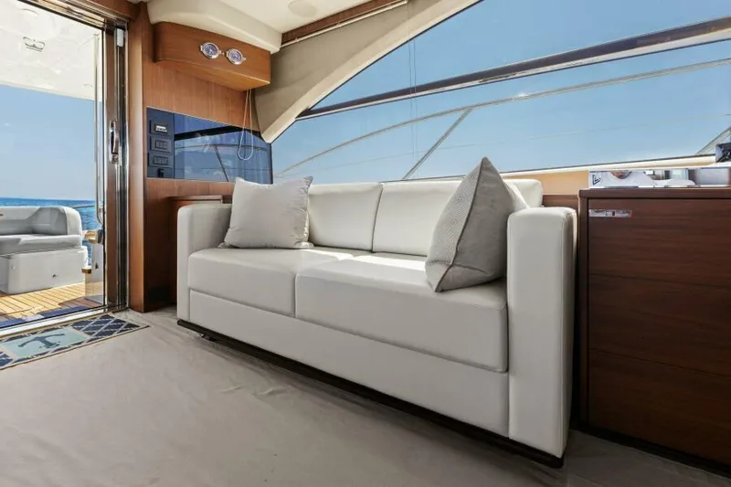 Princess Rose Too Yacht Photos Pics Luxurious interior of 2016 Princess 60 Flybridge yacht with white sofa and ocean view.