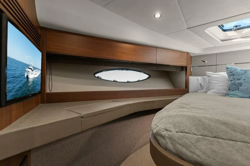 Princess Rose Too Yacht Photos Pics Luxurious cabin interior of 2016 Princess 60 Flybridge yacht with cozy bed and porthole view.