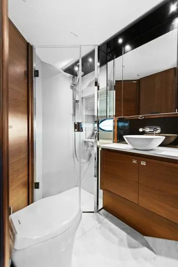Princess Rose Too Yacht Photos Pics Luxurious bathroom on 2016 Princess 60 Flybridge yacht with modern fixtures and wood accents.