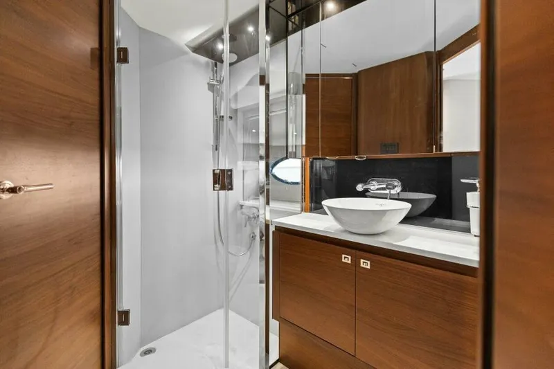 Princess Rose Too Yacht Photos Pics Luxurious bathroom in 2016 Princess 60 Flybridge yacht with modern fixtures and wood accents.