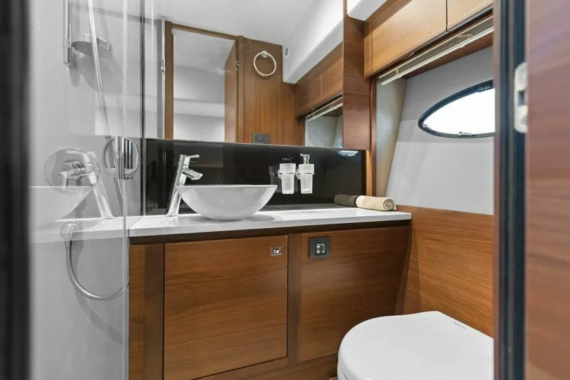 Princess Rose Too Yacht Photos Pics Luxurious bathroom in 2016 Princess 60 Flybridge yacht with modern fixtures and wood accents.