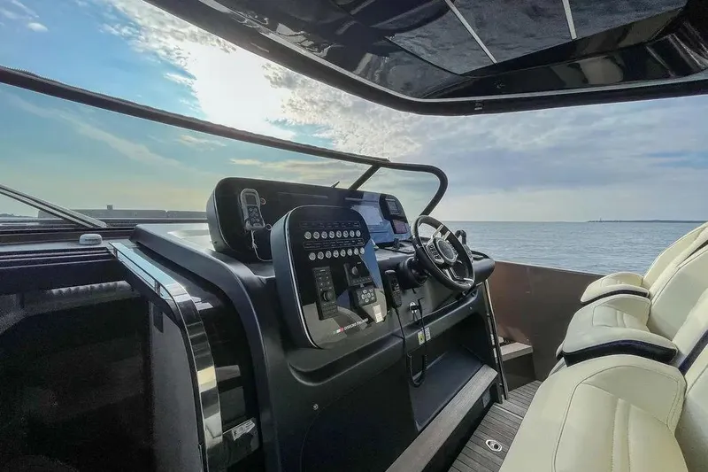  Yacht Photos Pics Cockpit of 2021 Cranchi A46 Luxury Tender with modern controls and ocean view.