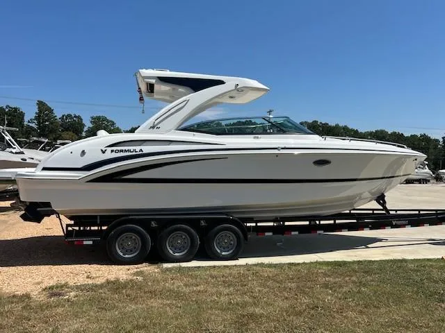  Yacht Photos Pics 2025 Formula 310 Bowrider I/O boat on trailer, sleek design, parked outdoors.