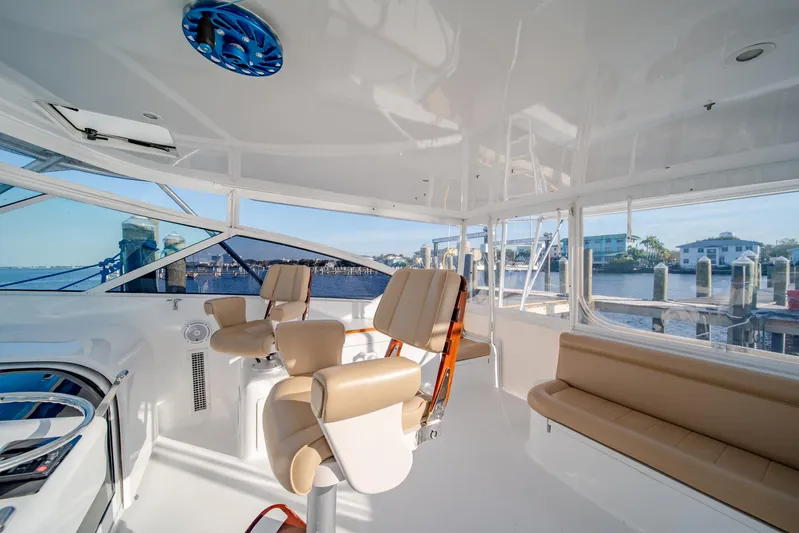 Urgent Sea Yacht Photos Pics Interior of 2003 Viking 45 Express yacht with beige seating and panoramic windows.