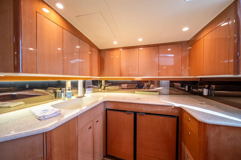 Urgent Sea Yacht Photos Pics Luxurious kitchen interior of 2003 Viking 45 Express yacht with wooden cabinets and modern amenities.