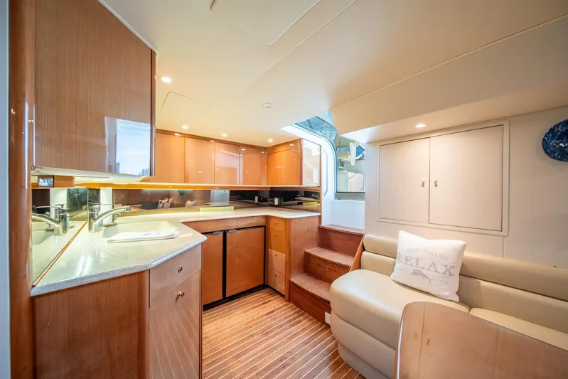 Urgent Sea Yacht Photos Pics Interior of 2003 Viking 45 Express yacht with modern kitchen and cozy seating area.
