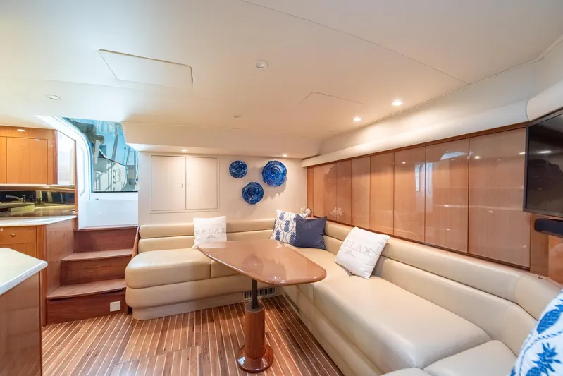 Urgent Sea Yacht Photos Pics Luxurious interior of 2003 Viking 45 Express yacht with elegant seating and wooden finishes.