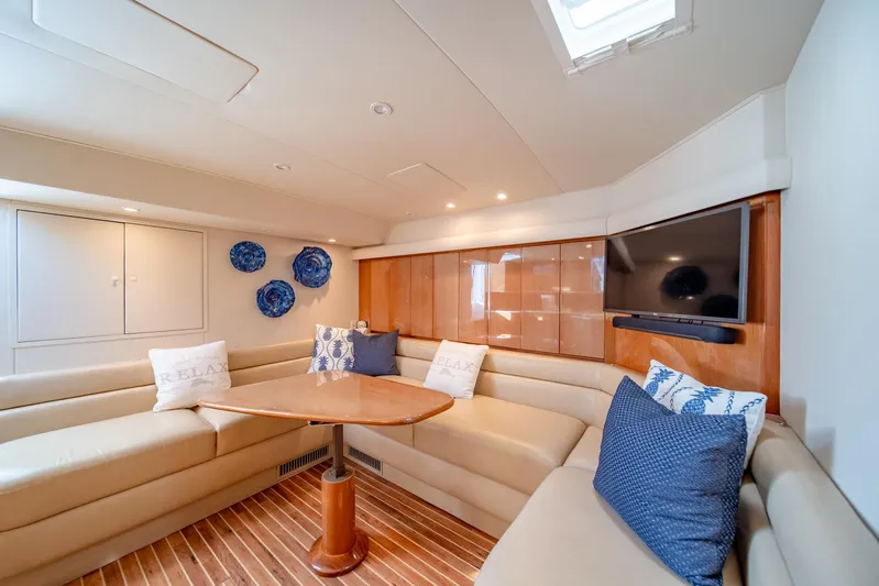 Urgent Sea Yacht Photos Pics Luxurious interior of 2003 Viking 45 Express yacht with plush seating and elegant decor.