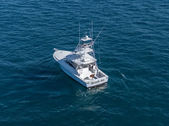 Urgent Sea Yacht Photos Pics 2003 Viking 45 Express boat on open ocean waters.