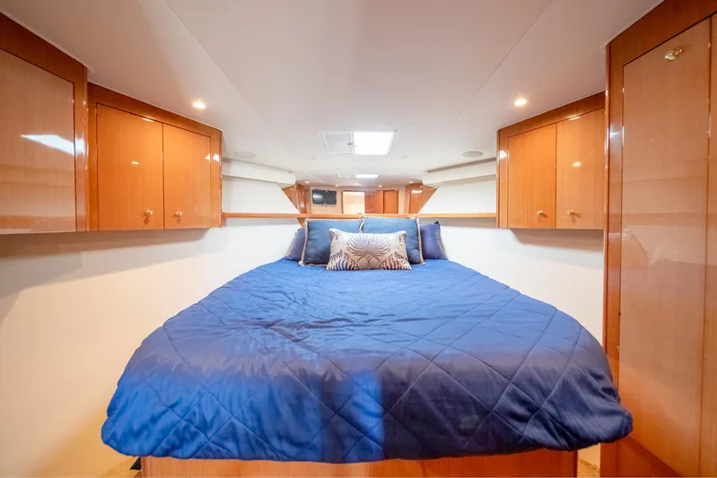 Urgent Sea Yacht Photos Pics Luxurious cabin interior of 2003 Viking 45 Express yacht with blue bedding.