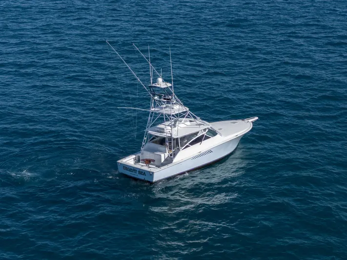 Urgent Sea Yacht Photos Pics 2003 Viking 45 Express boat cruising on open blue water.