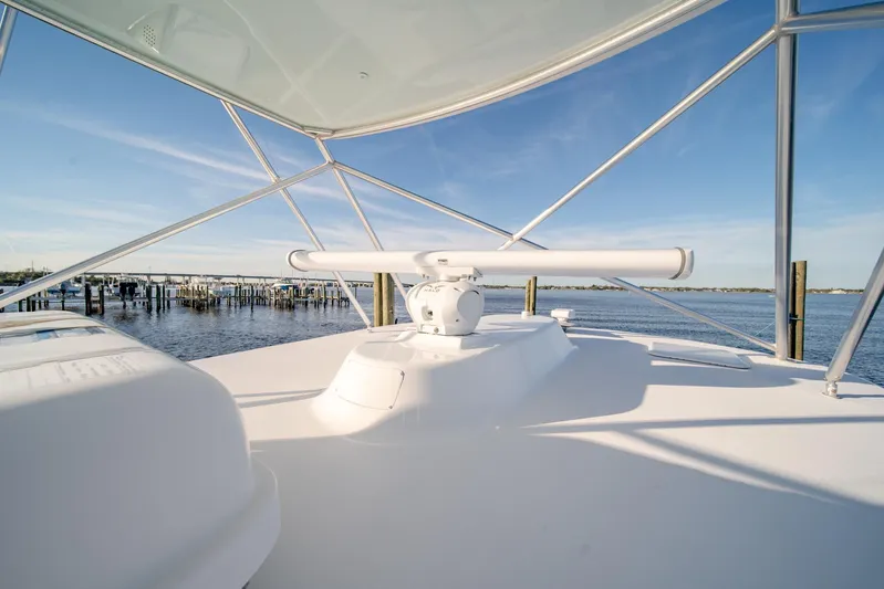 Urgent Sea Yacht Photos Pics 2003 Viking 45 Express yacht deck with radar, overlooking serene waterfront.