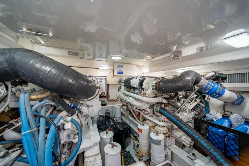 Urgent Sea Yacht Photos Pics Engine room of 2003 Viking 45 Express yacht, showcasing complex machinery and piping.