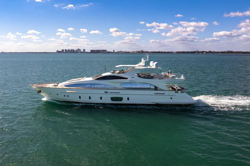 Babieca Yacht Photos Pics Luxurious 2005 Azimut 105 yacht cruising on open water under a clear blue sky.