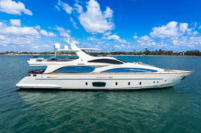 Babieca Yacht Photos Pics Luxurious 2005 Azimut 105 yacht cruising on clear blue waters under a vibrant sky.